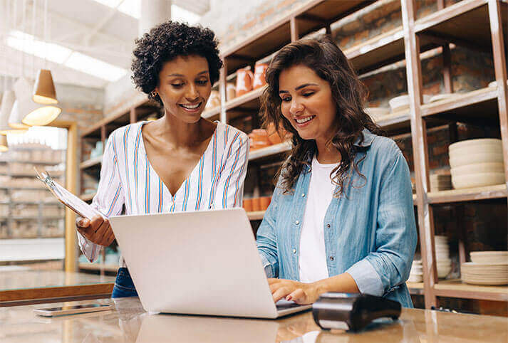 two employees of a small business looking at a laptop_01